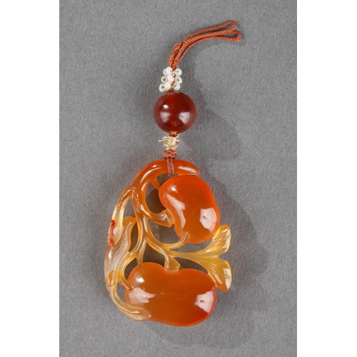 Cornaline pendant in the shape of two fruits and their foliage with a bird